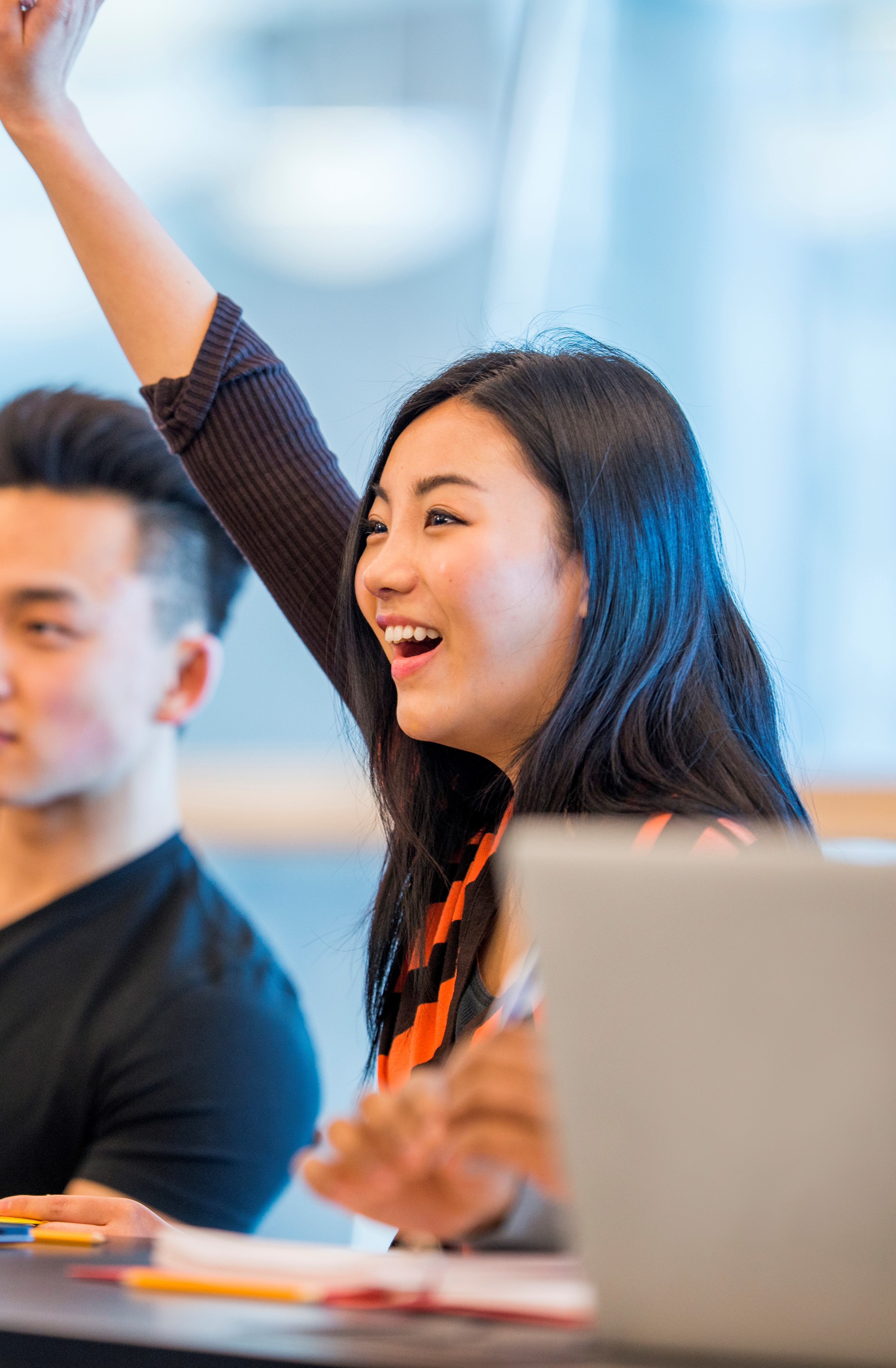 Student raising hand in class