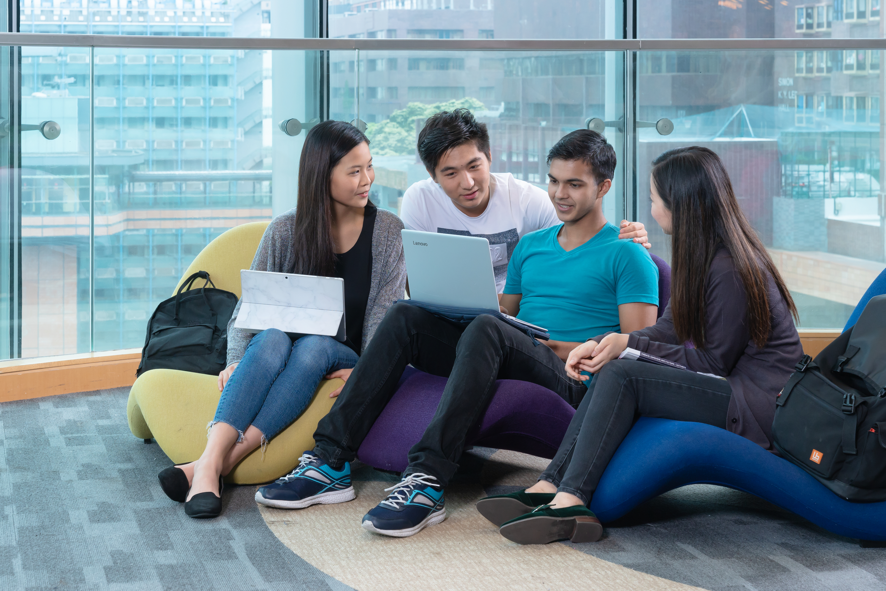 Four students are chatting on 2/F of Chi Wah Learning Common