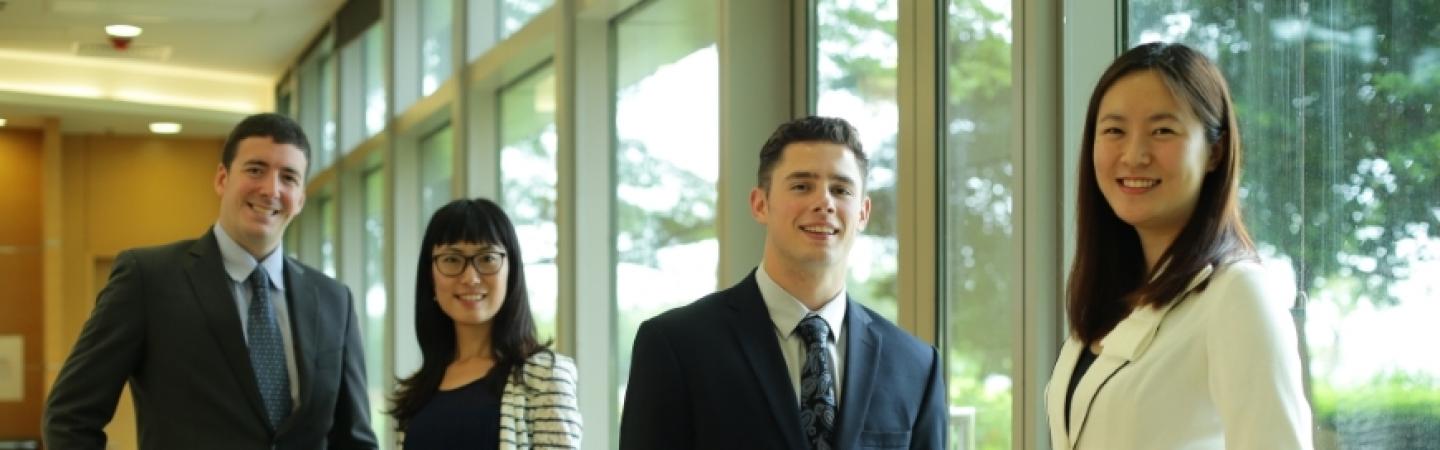 Business students from different nationalities smiling into camera