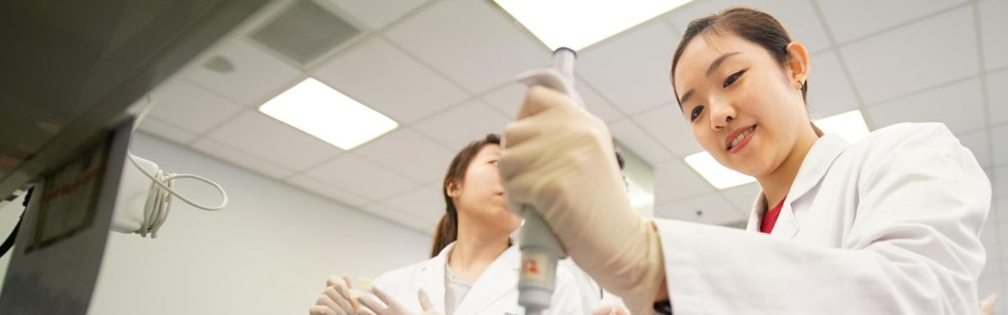 Student working in lab with lab coat