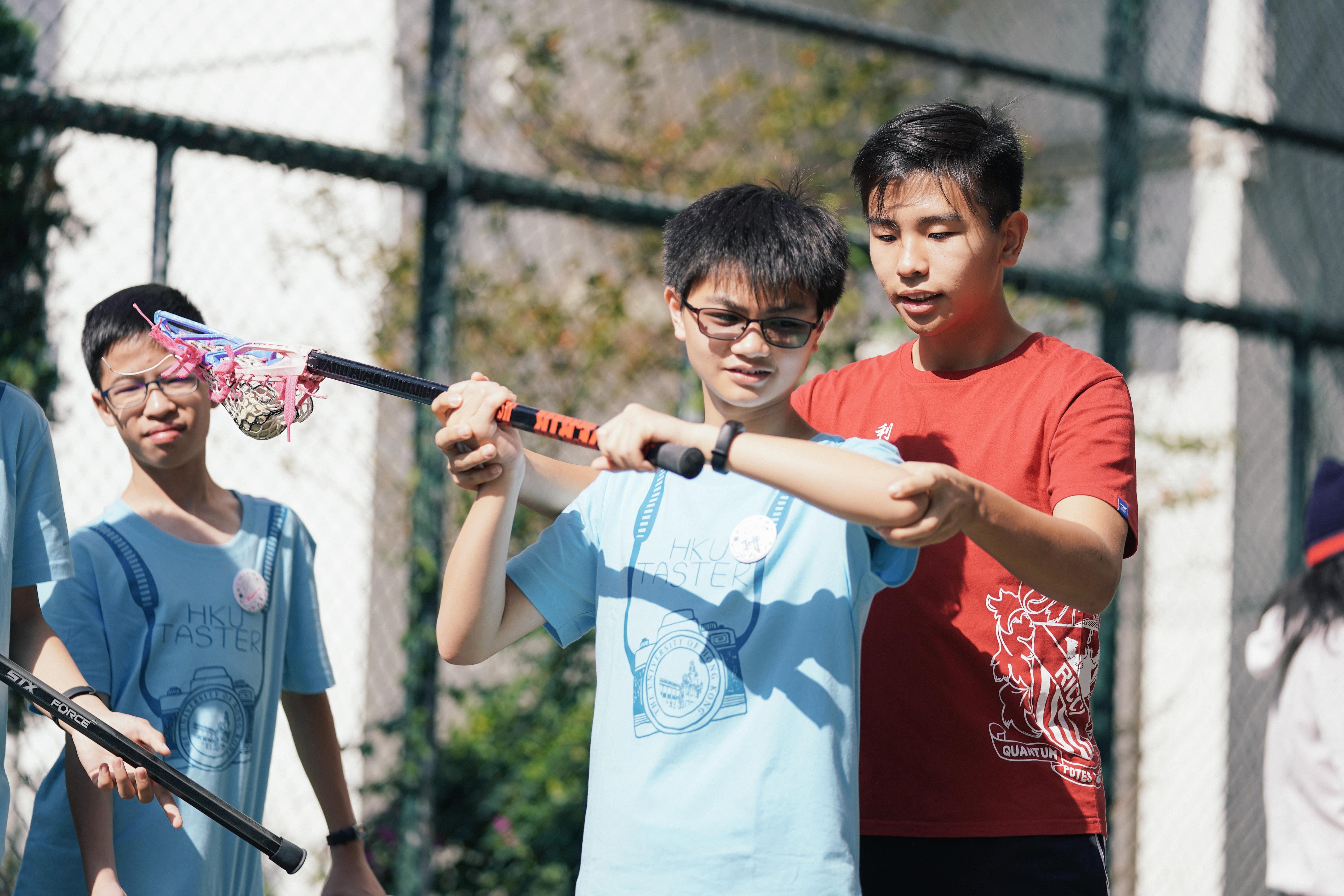 Students are learning how to play lacrosse