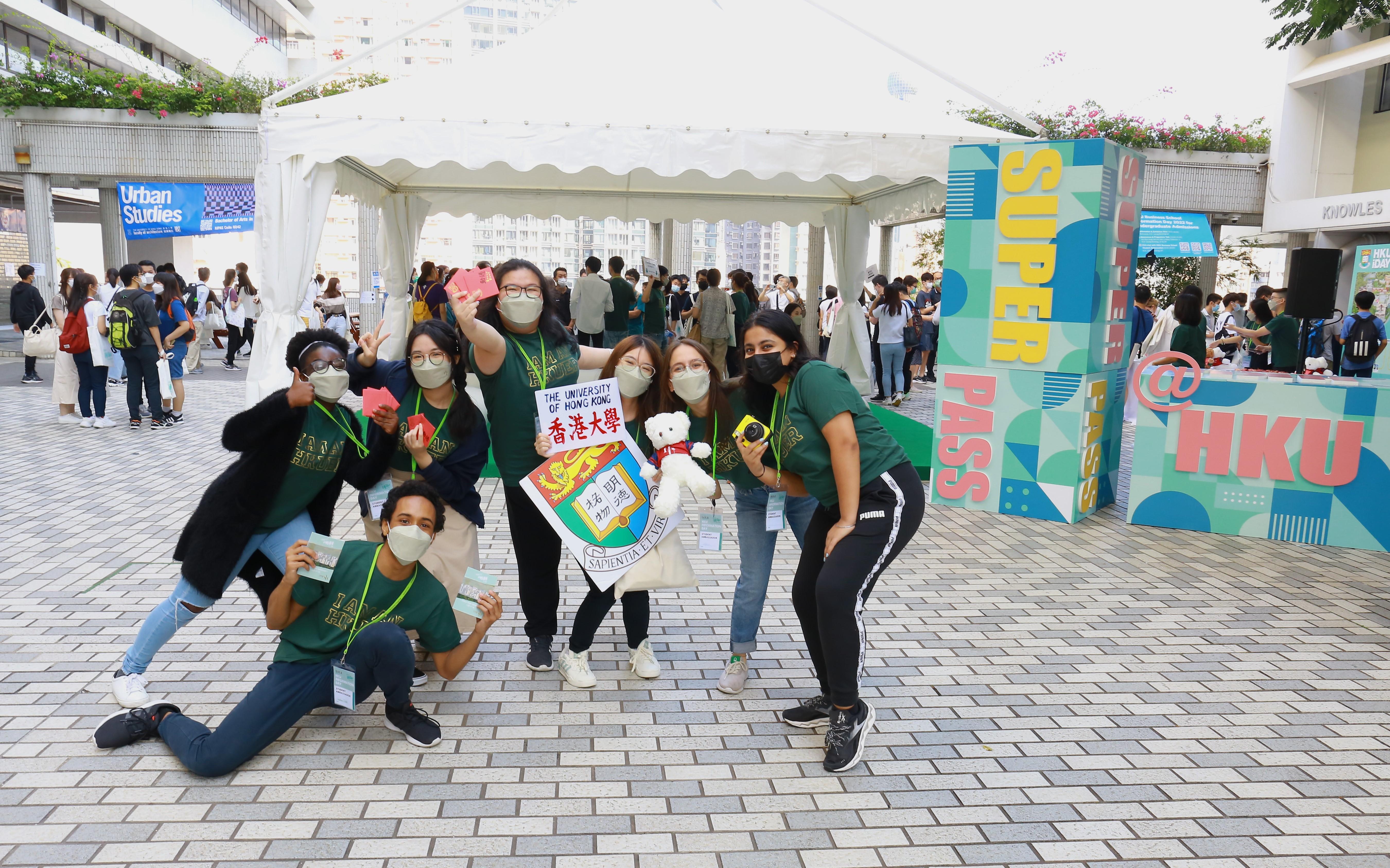 Students ambassadors are posing in front of SUPERPASS Booth at HKU Information Day