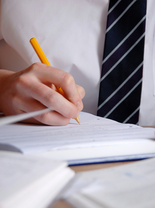 Students is writing on a notebook