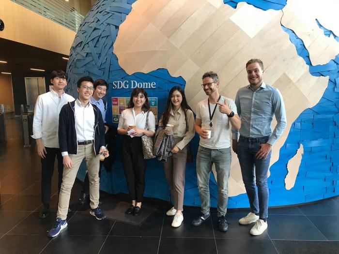 Group of students standing in front of the PwC SDG Dome