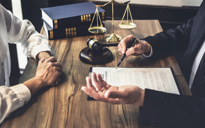 Two people conversing with a court scale on table