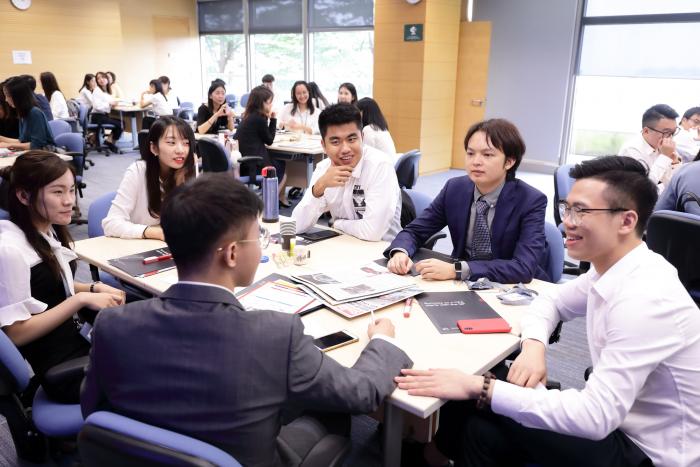 Business students in formal attire discussing