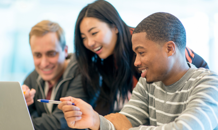 Students are pointing at a computer screen