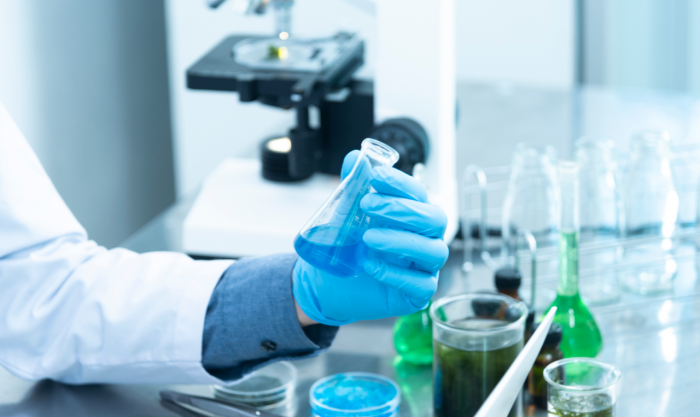 Researcher working on a testing fluid in a laboratory