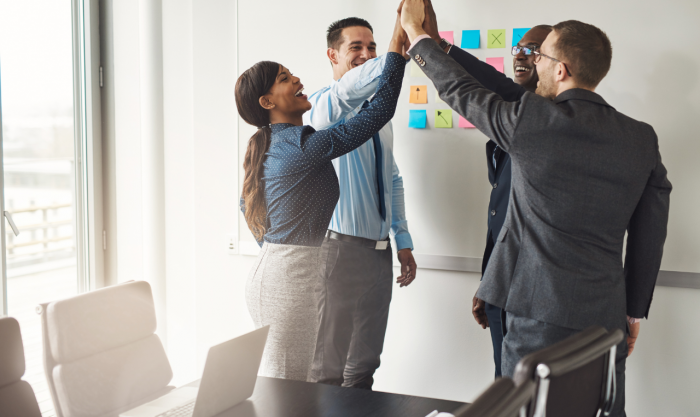 Business team giving a high fives gesture