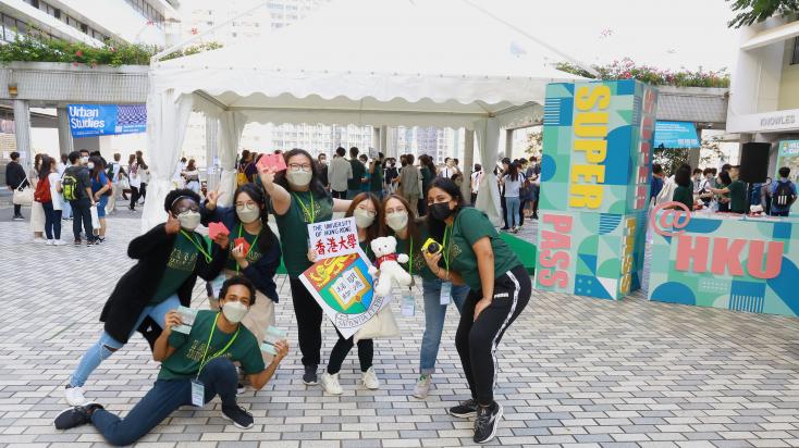 Students ambassadors are posing in front of SUPERPASS Booth at HKU Information Day